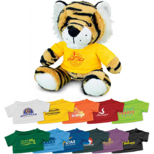 A plush toy tiger with orange and black stripes, wearing a yellow shirt featuring a logo.