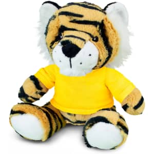 A plush tiger toy with orange and black stripes, wearing a yellow shirt, seated and smiling. It has a branded logo.