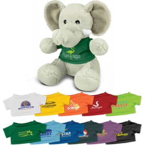 A grey elephant plush toy wearing a green shirt with a logo, displayed alongside various coloured shirts.