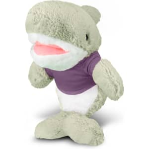 A plush shark toy in light green, wearing a purple shirt, with a soft and friendly expression.