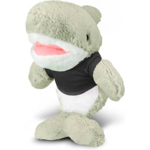 A plush shark toy in light green with a white belly, wearing a black shirt, featuring a friendly expression.