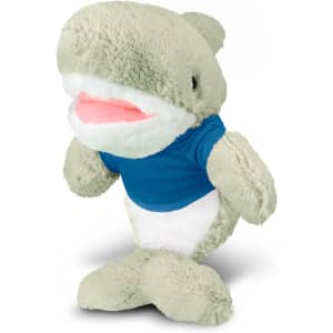 A green shark plush toy wearing a blue shirt, featuring soft fabric and a friendly expression.