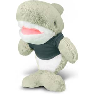 A green shark plush toy wearing a dark shirt, featuring a soft body and smiling expression.