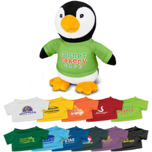 A plush penguin toy wearing a green shirt, surrounded by various small shirts in different colours and designs.