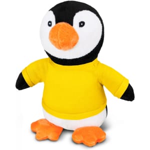 A plush penguin toy wearing a yellow T-shirt, with black and white body and orange beak and feet.