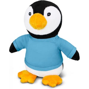 A penguin plush toy featuring black and white fur, orange feet, and wearing a blue shirt. It has a logo on it.