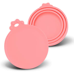 A set of three pink silicone reusable can lids with a round design and a grip handle on top.