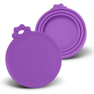 A set of two round purple silicone lids with a textured handle on one. Each lid is smooth and flexible.