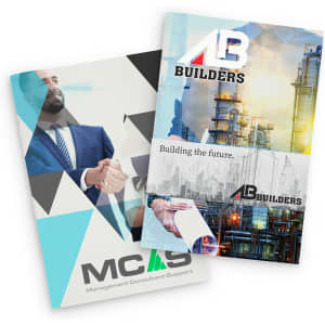 A medium notebook with a colourful, geometric cover and images related to construction, featuring branding elements.
