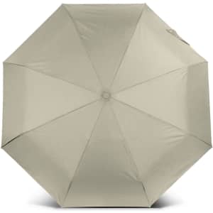 A compact umbrella in a light khaki colour with an octagonal shape and a central opening mechanism. It has a logo.