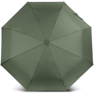 A compact umbrella in a muted green colour with a circular design and a central button mechanism.