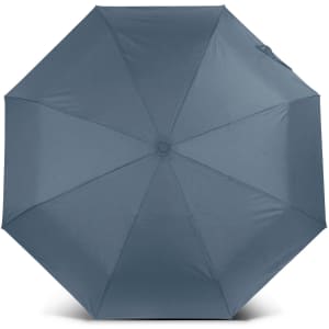 A compact umbrella in a solid slate grey colour with a central button and a sleek design. It features a logo.