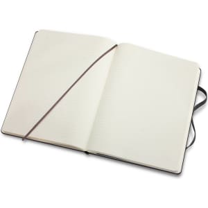 An extra large, black Moleskine classic hard cover notebook with blank lined pages, featuring an elastic band and ribbon bookmark.
