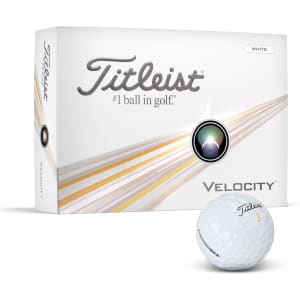 A white golf ball with a logo, next to a box of Titleist Velocity golf balls featuring colours of white and silver.