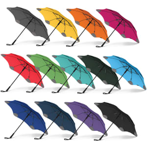 A set of colourful BLUNT Classic Umbrellas in grey, yellow, red, green, blue, black, and purple. Each features a logo.