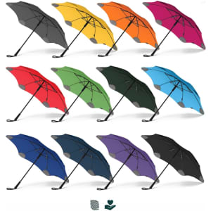 A collection of BLUNT Classic Umbrellas in various colours, including black, grey, yellow, pink, green, red, blue, and purple.