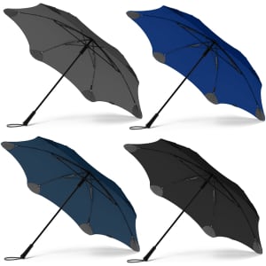 A set of four BLUNT Exec Umbrellas in grey, blue, teal, and black, each with a logo on the canopy.