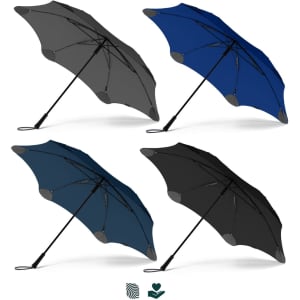 A collection of BLUNT Exec Umbrellas in grey, navy blue, teal, and black, featuring a branded design.