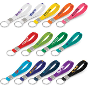 A collection of silicone key rings in various colours, each with a metal keyring attachment, featuring logos.