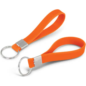 An orange silicone key ring with a debossed detail and a metal ring attachment.
