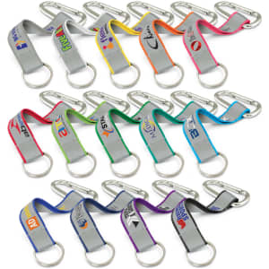 A collection of multi-coloured reflector key rings with metal carabiners, featuring various logos on the straps.