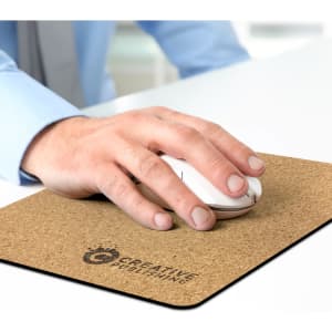 A hand using a white mouse on a cork-coloured mouse mat featuring a logo.
