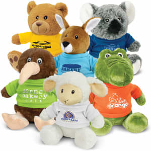 A variety of plush toys including a bear, kangaroo, kiwi, sheep, and crocodile, all wearing colourful shirts.