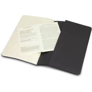 A Moleskine Cahier Journal, featuring a black cover with cream-coloured lined pages and additional inserts.
