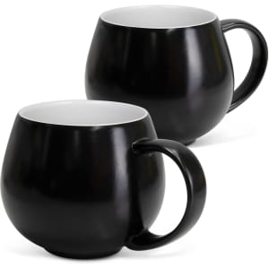 A drinkware set featuring two black coffee mugs with smooth finishes and white interiors. Each mug has a curved shape and handle.