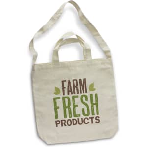 A cream cotton shoulder tote bag with long handles and a logo featuring "Farm Fresh Products" in green and brown text.