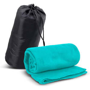 A teal fleece blanket rolled and resting beside a black carry bag with a drawstring closure.