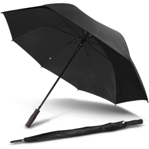A black Pro-Am umbrella lies open, with a folded version beside it, featuring a simple design and a handle.