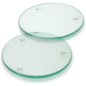 Two round glass coasters featuring a clear design with small grips on the bottom.