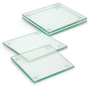 A set of four square glass coasters with a clear finish, featuring rounded edges and rubber grips at the corners.