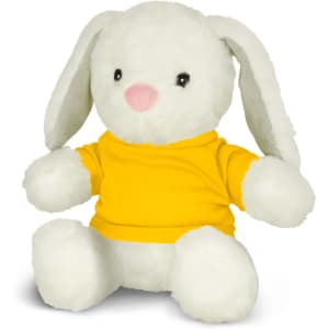A soft, white rabbit plush toy, wearing a bright yellow shirt, sitting upright with floppy ears.