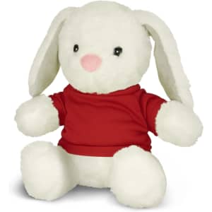 A plush rabbit toy with white fur, wearing a red shirt, sitting with its paws forward. It has a branding logo.
