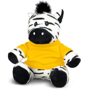 A zebra plush toy with black and white stripes, wearing a yellow shirt and featuring a tuft of fur on its head.