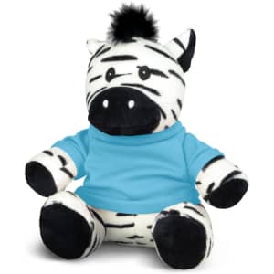 A plush zebra toy with black and white stripes, wearing a blue shirt. It has a black tuft of fur on its head.