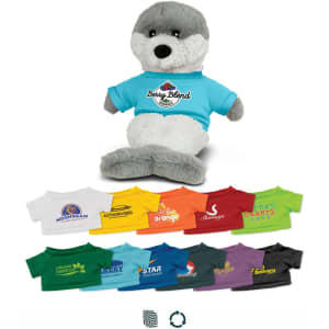 A grey and white seal plush toy wearing a blue shirt, accompanied by various coloured t-shirts in a row below.