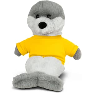A grey seal plush toy wearing a bright yellow shirt, sitting with a friendly expression. It has a soft, cuddly texture.