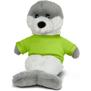 A grey and white plush seal toy wearing a bright green shirt, sitting up with a soft texture. The toy has a logo on its shirt.