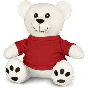 A plush white bear toy with a red shirt and black paw prints, featuring a cheerful smile and round ears.
