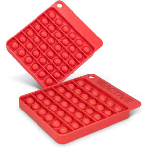 A red silicone Pop Bubble Board featuring a grid of bubbles in a square shape, with one board stacked on top of another.