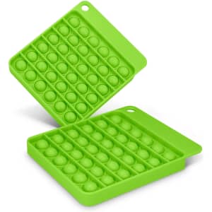 A green Pop Bubble Board featuring a grid of raised bubbles in a square shape, with a handle on one side.