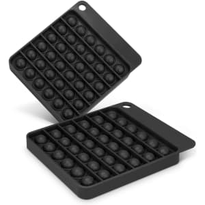 A black Pop Bubble Board with two sections, each filled with multiple bubble-like domes.