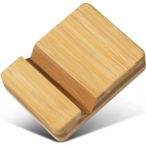 A bamboo phone stand in a natural finish with a sleek design and a slotted section for device placement.