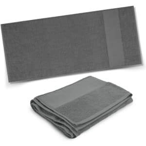 A dark grey bath towel displayed flat and another folded, featuring a subtle design and a logo.