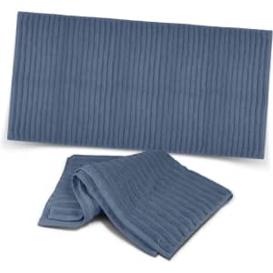 A dark blue luxury towel with a ribbed texture, featuring one folded towel and one flat towel below it.