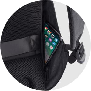 A black backpack with a mesh pocket, featuring a phone tucked into an exterior zippered compartment.