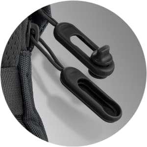 A close-up view of a black toggle and cord on a backpack, featuring sleek, functional design elements.